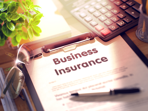 business insurance written out of paper on a clipboard