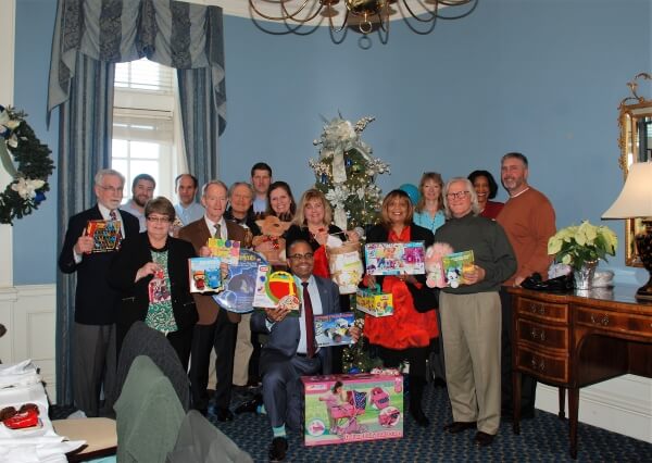 The Kinneman Insurance staff holding up the toys they purchased for the Adopt A Family program.
