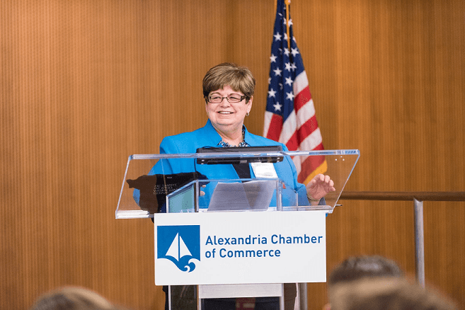 Virginia Kinneman at the podium of the Alexandria Chamber of Commerce during the 2018 40 under 40 awards