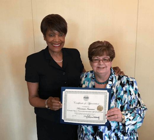 Virginia Kinneman receiving certificate of her sponsorship for the United Way in the Alexandria Step It Up! Senior Walk