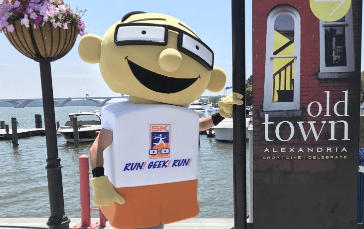 Run geek run event mascot beside an old town Alexandria sign